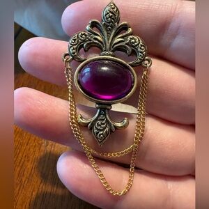 Begere brooch, antiqued gold toned purple cabachon, 2 gold toned dangle chains.